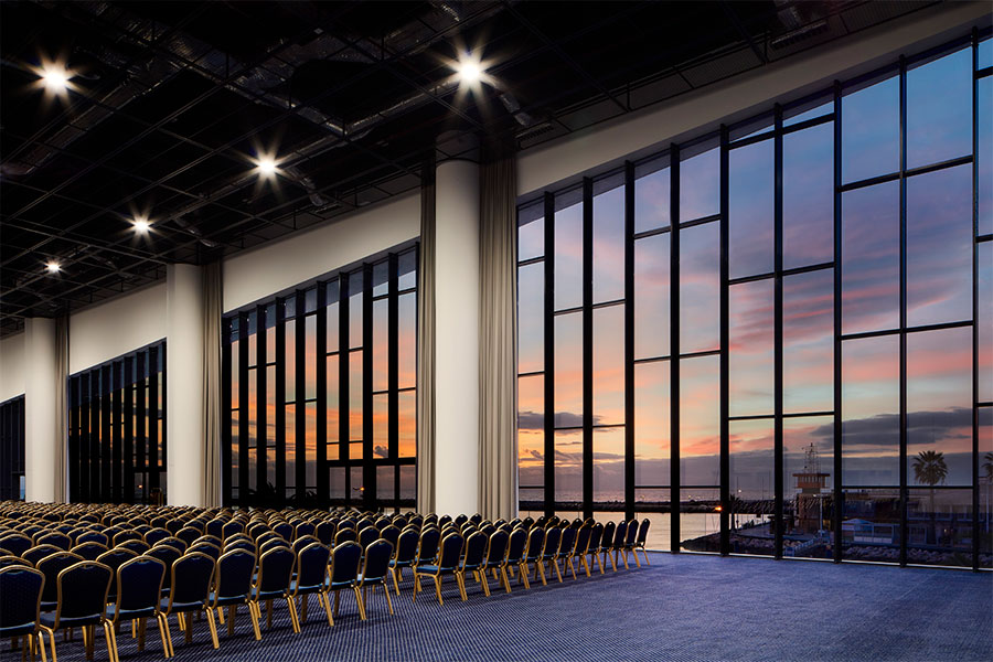 Meeting room in the Algarve Congress Centre with panoramic views over the ocean and Vilamoura Marina during the sunset
